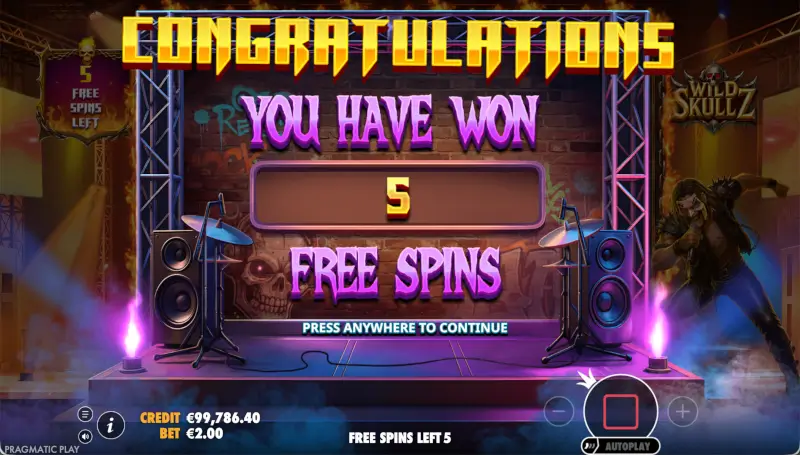 Wild Skullz bonus intro screen saying Congratulations you have won 5 free spins on a concert stage background
